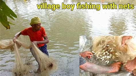 boy fishing|village boy fishing with just a nets .